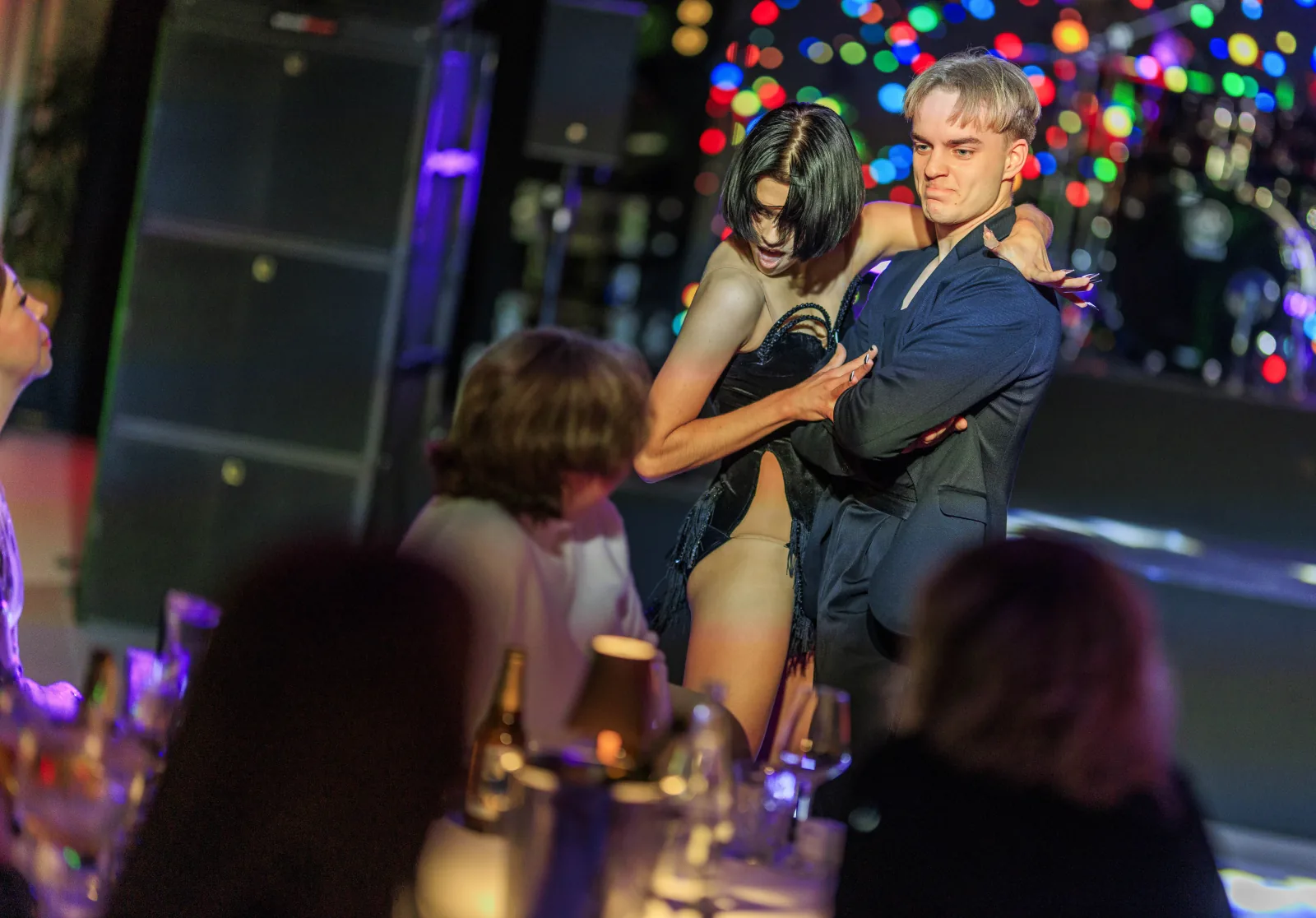 Professional dance couple performing among guests at a private celebration